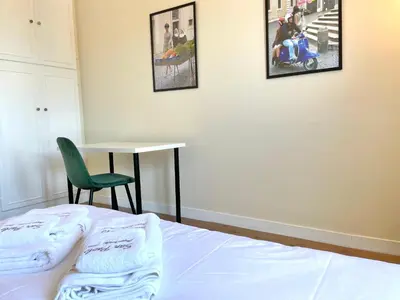 a bedroom with a bed and a table and a chair at Onesti House - San Paolo in Rome