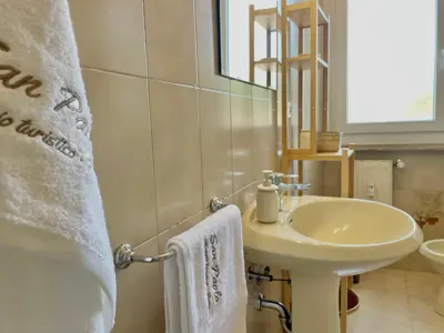 a white bathroom with a sink and a mirror at Onesti House - San Paolo in Rome
