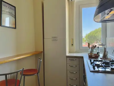 a kitchen with a stove and a sink and a window at Onesti House - San Paolo in Rome