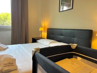 a hotel room with a bed and a couch at Onesti House - San Paolo in Rome
