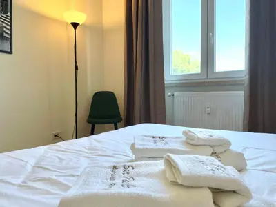 a bedroom with towels on a bed with a window at Onesti House - San Paolo in Rome