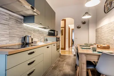 a kitchen with a wooden table and a dining room at La Casa di Umberto in Rome