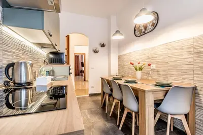 a kitchen and dining room with a wooden table and chairs at La Casa di Umberto in Rome