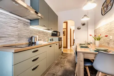 a kitchen with a table and a dining room at La Casa di Umberto in Rome