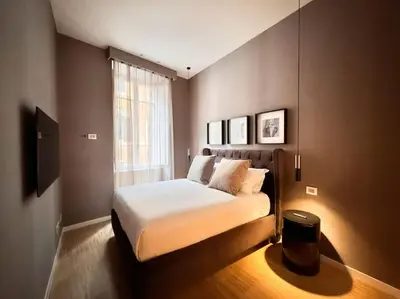 a bedroom with a bed and a window at The Condotti - Luxury serviced apartment in Rome