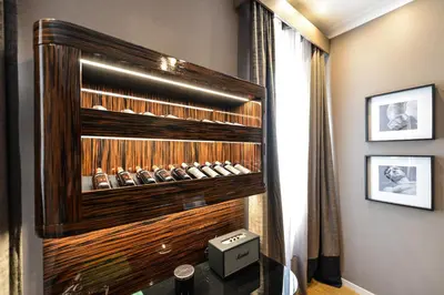 a room with a wooden cabinet with shoes in it at The Condotti - Luxury serviced apartment in Rome