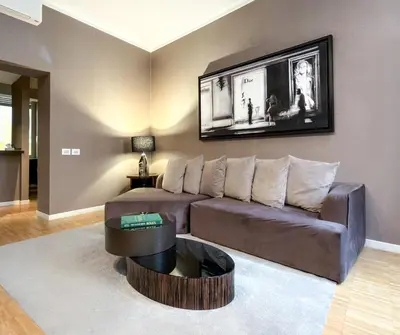 a living room with a couch and a table at The Condotti - Luxury serviced apartment in Rome