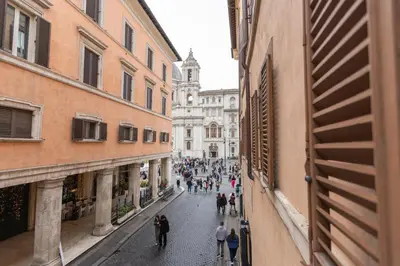 a group of people walking down a street between buildings at Piazza Navona Classy & Large Apartment in Rome
