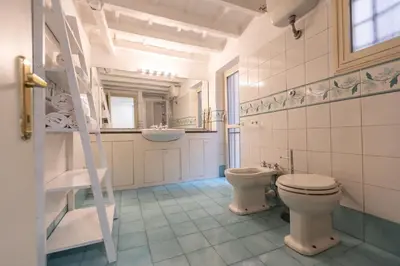 a bathroom with a toilet and a sink and a mirror at Piazza Navona Classy & Large Apartment in Rome