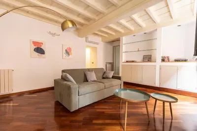 a living room with a couch and two tables at Piazza Navona Classy & Large Apartment in Rome