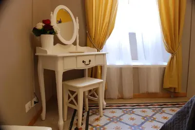 a white dressing table with a mirror and a stool at Costantino Primo Holiday - Roma St.Pietro in Rome