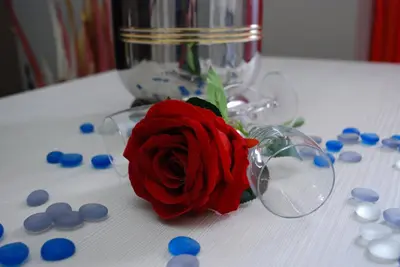 a red rose in a glass vase on a table at Costantino Primo Holiday - Roma St.Pietro in Rome