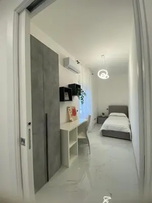 a bedroom with a bed and a desk in a room at Tiburtina Flats in Rome