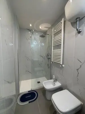 a bathroom with a shower and a toilet and a sink at Tiburtina Flats in Rome