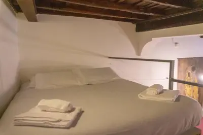 a bedroom with a bed with two towels on it at Domus Reginella, nella zona più richiesta di Roma in Rome