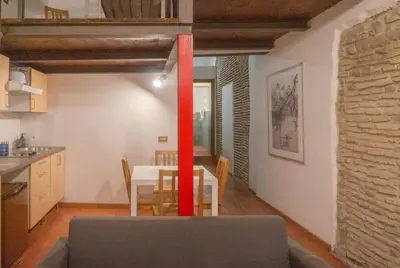 a kitchen and dining room with a table with a red ribbon at Domus Reginella, nella zona più richiesta di Roma in Rome