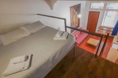 a bedroom with a white bed with at Domus Reginella, nella zona più richiesta di Roma in Rome
