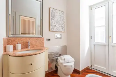 a bathroom with a sink and a toilet at Sant'Andrea - Opulence Apartment in Rome