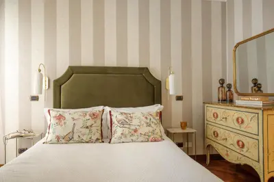 a bedroom with a bed with a mirror and a dresser at Sant'Andrea - Opulence Apartment in Rome