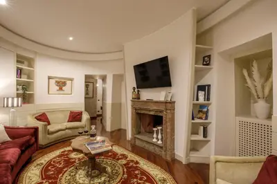 a living room with a fireplace and a tv at Sant'Andrea - Opulence Apartment in Rome