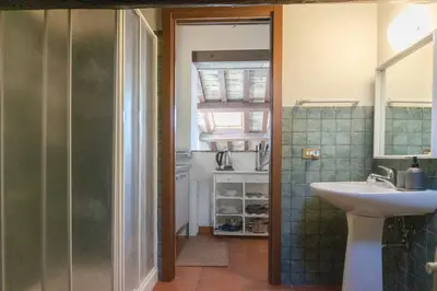 a bathroom with a sink and a mirror and a shower at Domus Tempio Deluxe, Roma Centro in Rome