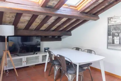 a dining room with a white table and a tv at Domus Tempio Deluxe, Roma Centro in Rome