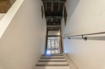 a hallway with stairs and a window in a building at Domus Tempio Deluxe, Roma Centro in Rome