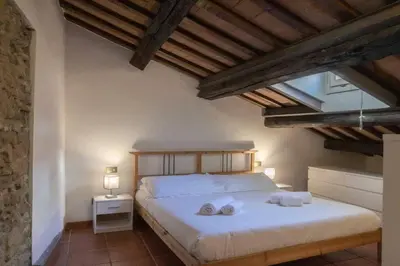 a bedroom with a bed with two towels on it at Domus Tempio Deluxe, Roma Centro in Rome