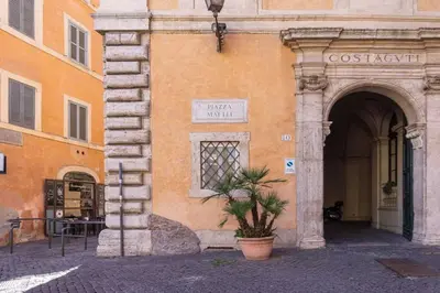 a building with a potted plant in front of it at Domus Tempio Deluxe, Roma Centro in Rome