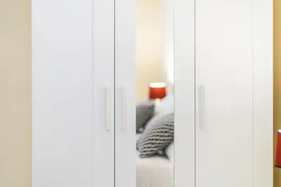 two white cupboards with a couch in a room at Domus Leo Roma in Rome