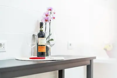 a bottle of wine and two glasses on a table at Domus Leo Roma in Rome