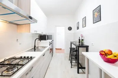 a kitchen with white cabinets and a counter top at Domus Leo Roma in Rome
