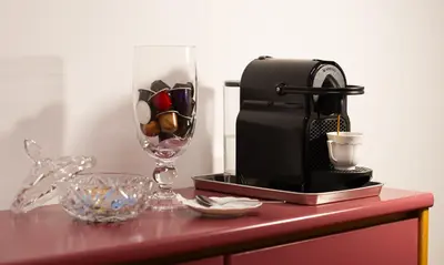 a table with a coffee maker and a glass at Yes Holiday Rome in Rome