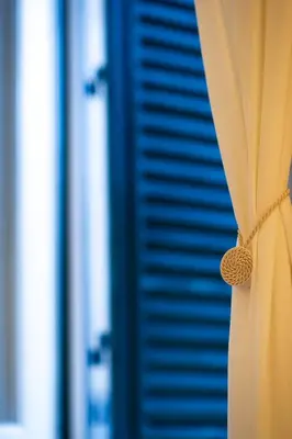 a close up of a curtain in front of a shutter at Yes Holiday Rome in Rome