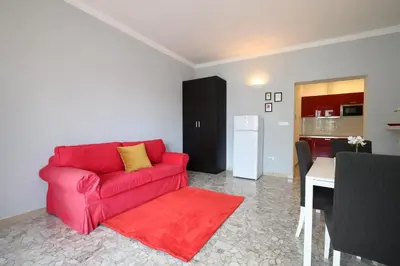 a living room with a red couch and a table at Opera 65 Roof Terrace in Rome