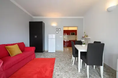 a living room with a red couch and a table at Opera 65 Roof Terrace in Rome