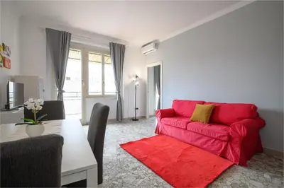 a living room with a red couch and a table at Opera 65 Roof Terrace in Rome