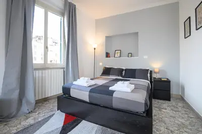 a bedroom with a bed and a large window at Opera 65 Roof Terrace in Rome