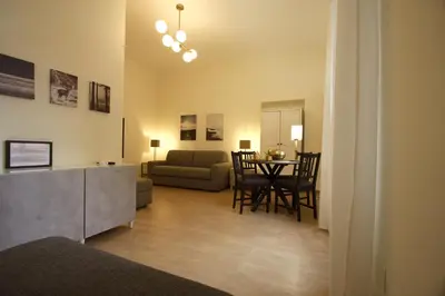 a living room with a kitchen and a dining room at San Lorenzo Holiday House in Rome