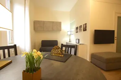 a living room with a table and a couch and a television at San Lorenzo Holiday House in Rome