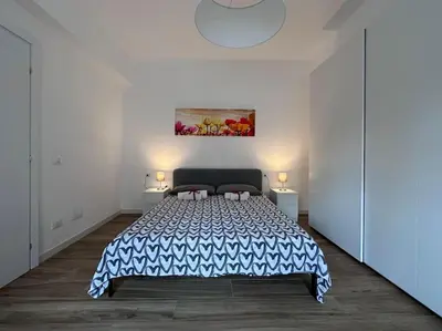 a bedroom with a large bed in a white room at Otium - Tarquinia in Rome