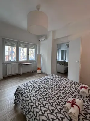a bedroom with a large bed with a black and white blanket at Otium - Tarquinia in Rome