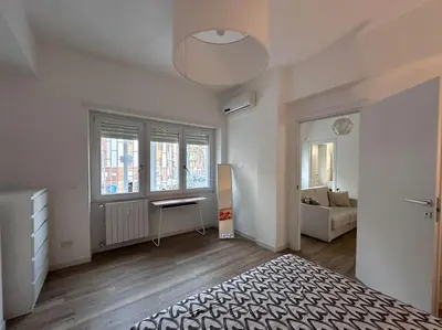 a white room with a bed and a window at Otium - Tarquinia in Rome