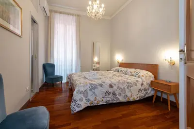 a bedroom with a bed and a table and a chair at Jubilee apartment Vatican Museums in Rome