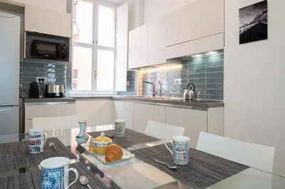 a kitchen with a table with a plate of food on it at Jubilee apartment Vatican Museums in Rome