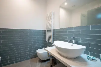 a bathroom with a white sink and a toilet at Jubilee apartment Vatican Museums in Rome