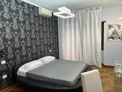 a bedroom with a bed and a black wall at Suite and room in Rome