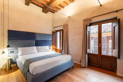 a bedroom with a large bed and a window at Residenza Leutari in Rome