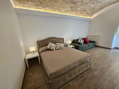 a bedroom with a bed and a couch at Campani Luxury Suite in Rome