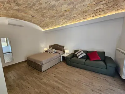 a living room with a bed and a couch at Campani Luxury Suite in Rome